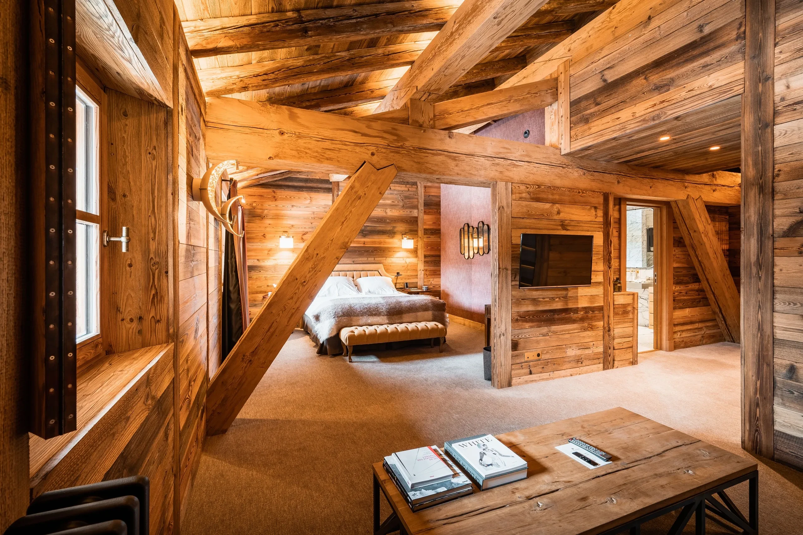 Chambre en bois avec lit et télévision, Hôtel de luxe La Mourra à Val d’Isèr