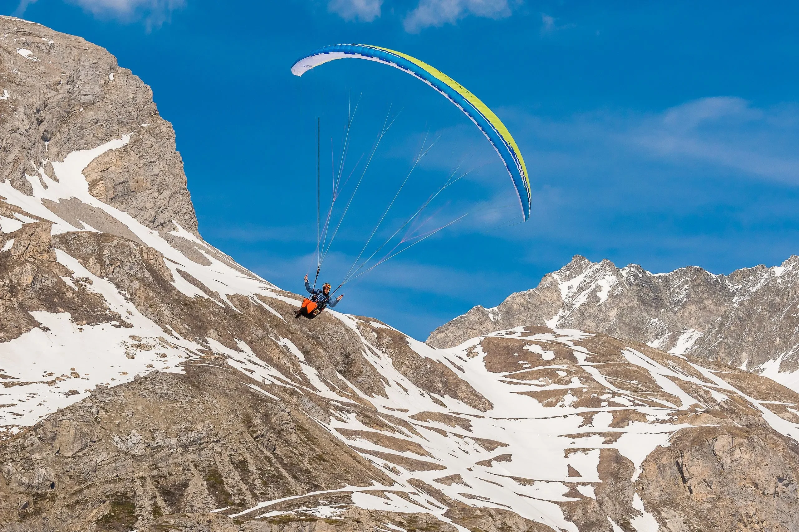Parapente au-dessus des montagnes enneigées, l'hôtel Village La Mourra pour un séjour à Val d’Isère